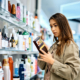 Young woman buying beauty products in drugstore