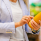 Woman reading ingredients and nutrition information on juice bottle