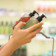 hands comparing skincare or body care liquid products